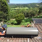 Plumbers and gas fitters installing solar hot water system on roof - hot water installation Ballina, NSW