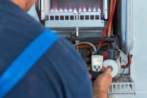 gas fitter checking gas heater - Gas Fitting Ballina, NSW